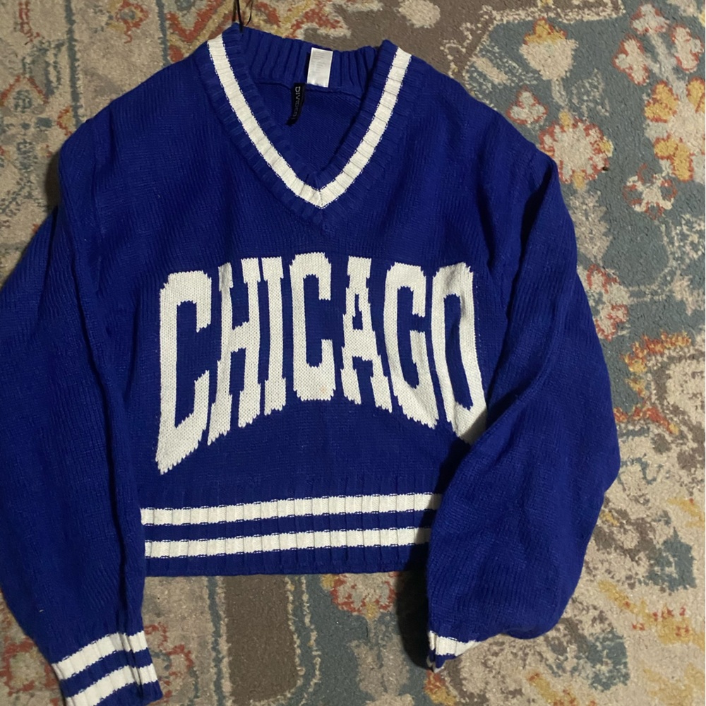 This is a blue cropped sweater that includes a V neck. Size XXS